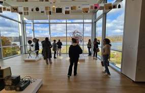 A gallery at the Hudson River Museum with large windows overlooking the Hudson River.