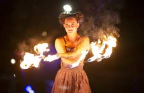 A woman performs with fire at Twilight Village.