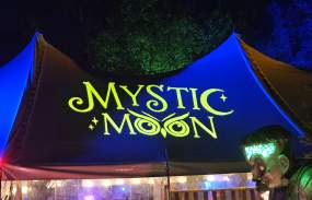 A tent displaying the name of the Mystic Moon event.