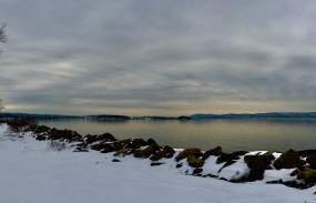 The snow-covered riverfront of Croton Point Park at sunset.