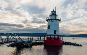 The sun sets over the Hudson River and Tarrytown lighthouse.