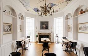 The dining room of Goosefeather with art painted on the ceiling.