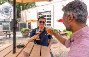 Broken Brewery Toast with two guests in beer garden