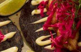 A plate of food garnished with limes.