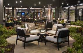 A grouping of plush seats on an outdoor patio.