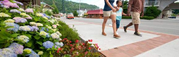 Family Walking Along Street