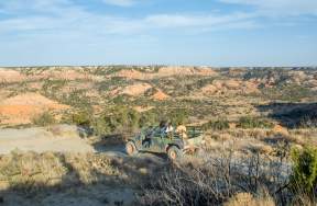 Group of friends in humvee overlooking palo duro canyon