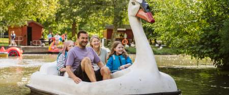 Family riding a swan pedalo in singleton park
