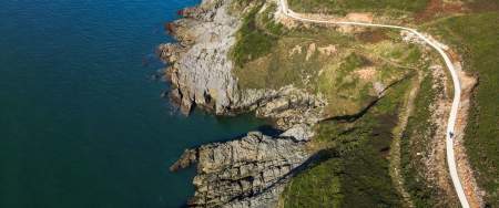 Gower coast path drone overlooking coastal path at cliffs seafront