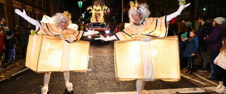 dancers dressed as light up christmas presents on rollerskates in the swansea christmas parade