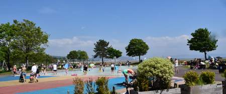 families playing in the water in the summer sun at blackpill lido