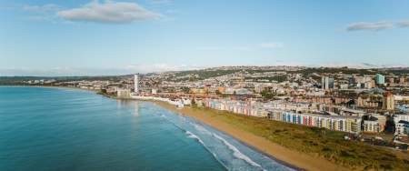 Aerial view of the swansea bay coastline with the marina and city
