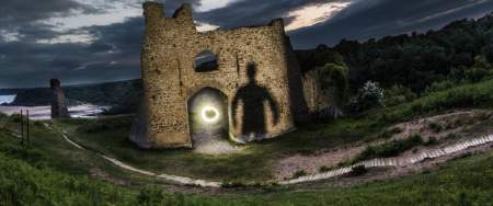Creepy silouhette against castle at night time