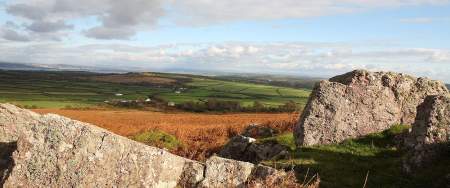 Rural Gower landscape with a rock formation in the foreground.