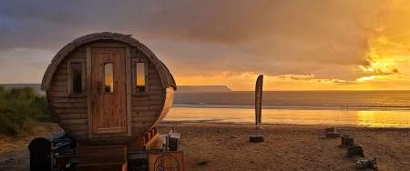 Small round wooden sauna on the beach