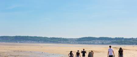 Students walking along Swansea Bay Beach