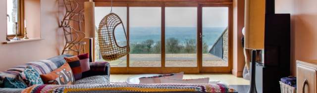 A room with a large window overlooking a countryside view at Yeo Valley Bristol