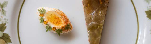 Overhead view of plate with apple pie and decorated deviled egg.