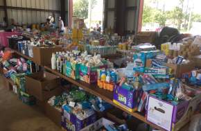 Disaster relief goods organized in boxes and on tables