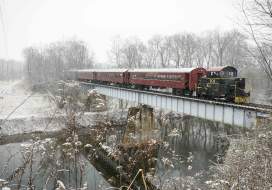 Walkersville Southern Railroad Santa Train going over a bridge during the snow