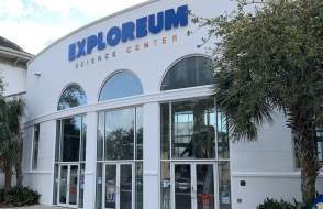 two-story building with three arched doorways