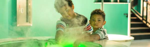 Two boys enjoying science center exhibit