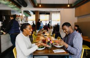 Couple sitting and dining at cafe