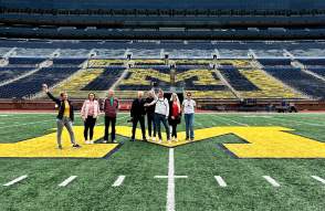 Tour group standing on field of Michigan Stadium