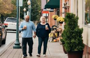 Couple in walking on sidewalk along Chelsea main street