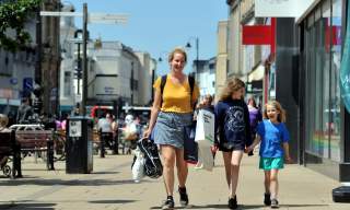 A family shopping on the High Street in Cheltenham.