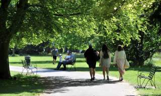 People walking through Cheltenham parks and gardens.