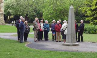 Guided tour group standing next to the Obelisk in Castle Park