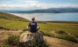 Man sitting on a rock looking out over the landscape