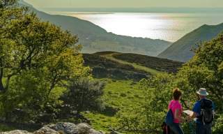 View of two walkers looking out over Sychnant Pass