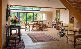 View of a large open plan dining room and living room at Kingham Cottages