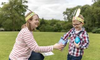 a woman and a child wearing easter bunny ears at buckfast abbey
