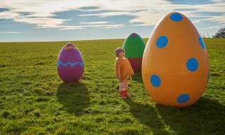 child with giant easter eggs