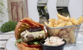 burger, chips and salad on a table in Budleigh