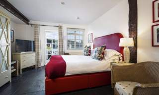 hotel room with a bed and an armchair