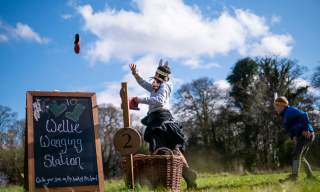 children on a sunny day tossing a welly
