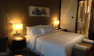 hotel room with bed side lights switched on