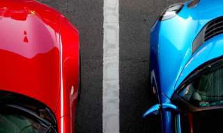 two cars in parking spaces