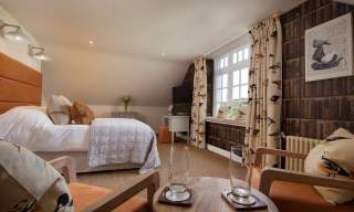 bedroom with double bed curtains and withe throw