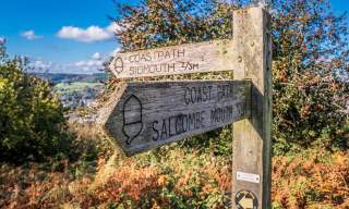 wooden sign for coast path for sidmouth and salcombe