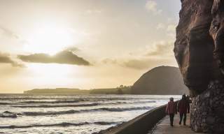 couple walking along the Jurassic Coast
