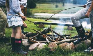 a family roasting marshmallows over a fire