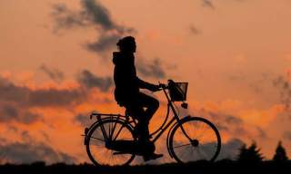 person cycling against the sun