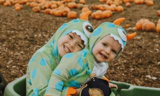 Children in fancy dress in pumpkin patch