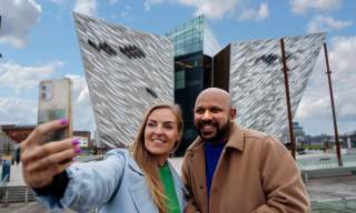 Couple taking a selfie in front of Titanic Belfast