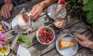 A table with cakes, fruit and coffee at Great Dixter, Sussex